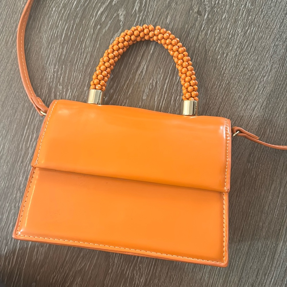 Orange Zara beaded top handle orange mini bag with adjustable cross body strap.